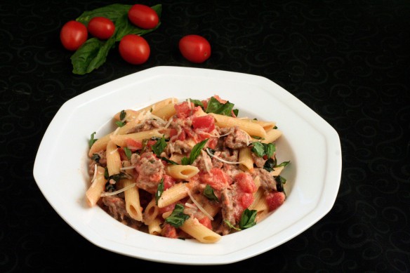 Penne pasta with sausage and fresh basil in a cream sauce